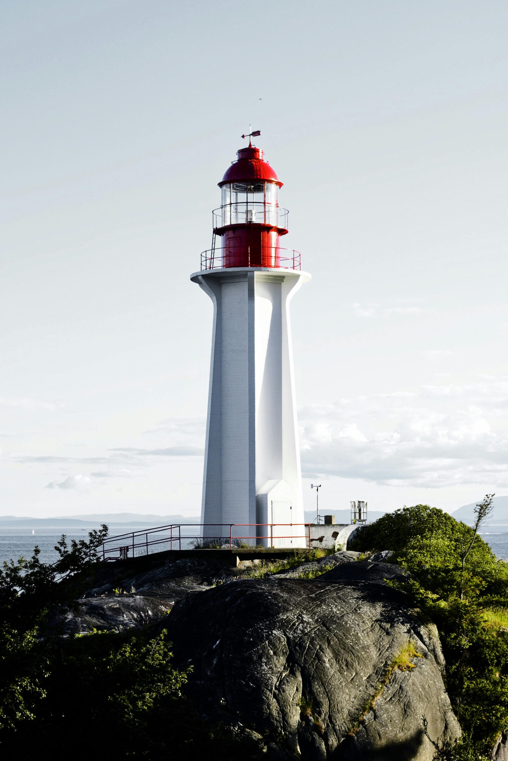 Beautiful lighthouse standing on the rocky shore of West Vancouver with scenic ocean backdrop.